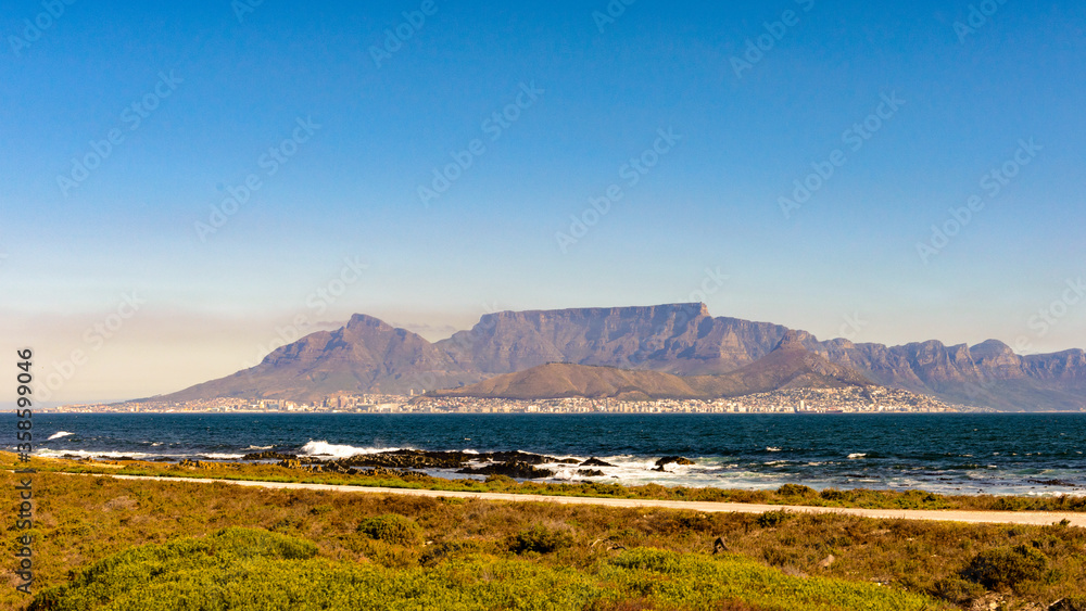 It's Table Mountain, touristic attraction, with many visitors using the cableway or hiking to the top. South Africa