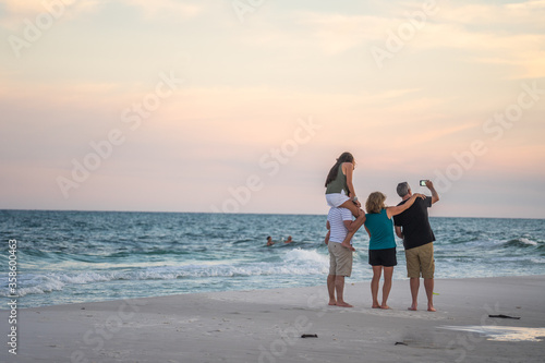 united loving family taking a selfie all together in Pensacola beach, florida. © Alejandro