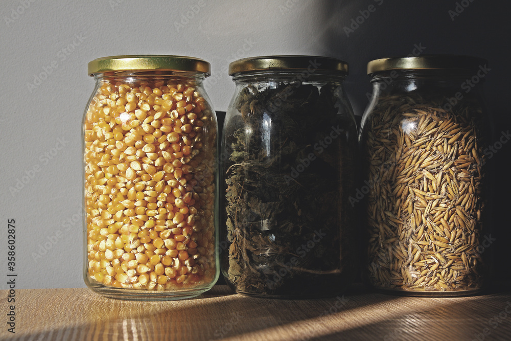 Herbs, cereals and corn in jars for storage in the pantry Herbs, cereals and corn in jars for storage in the pantry