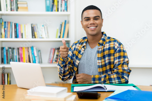 Successful hispanic computer science student with braces photo