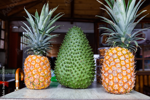 A huge soursop and pineapples