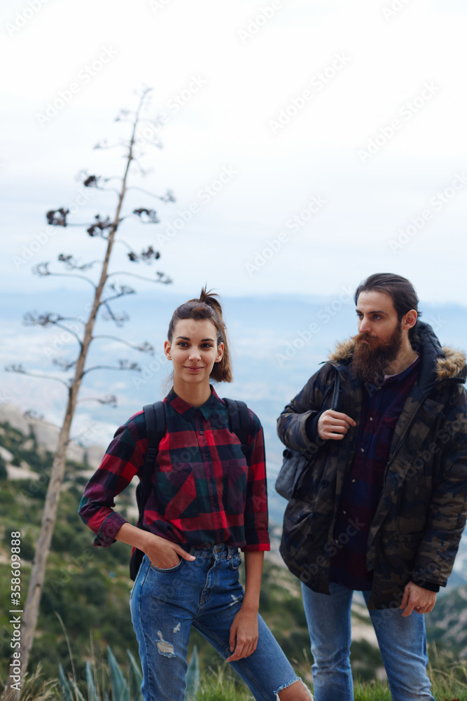 Beautiful couple of backpackers enjoying a day out in nature together