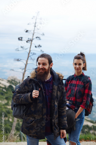 Portrait of laughing couple of hikers enjoying outdoors while out hiking in mountains