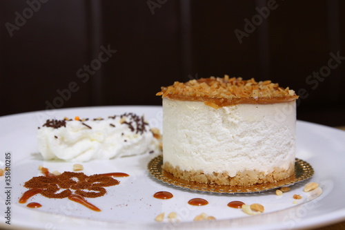 Cheesecake with peanut crumbs and whipped cream