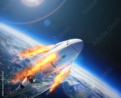 Fototapeta Naklejka Na Ścianę i Meble -  Crew Dragon spacecraft of the private American company SpaceX in space. Dragon is capable of carrying up to 7 passengers to and from Earth orbit, and beyond. Elements of this image furnished by NASA.