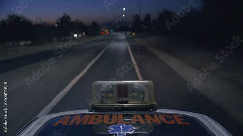 Speeding Ambulance With Emergency Lights Flashing On An Empty Highway. Anamorphic Lens.