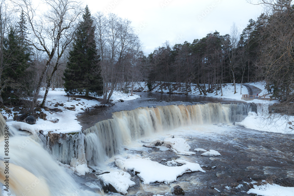 Partly frozen waterfall Keila in Estonia