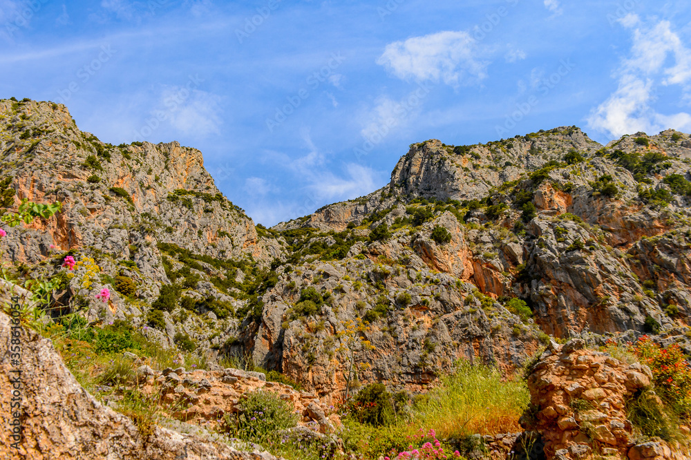 It's Delphi, an archaeological site in Greece, at the Mount Parnassus. Delphi is famous by the oracle at the sanctuary dedicated to Apollo. UNESCO World heritage