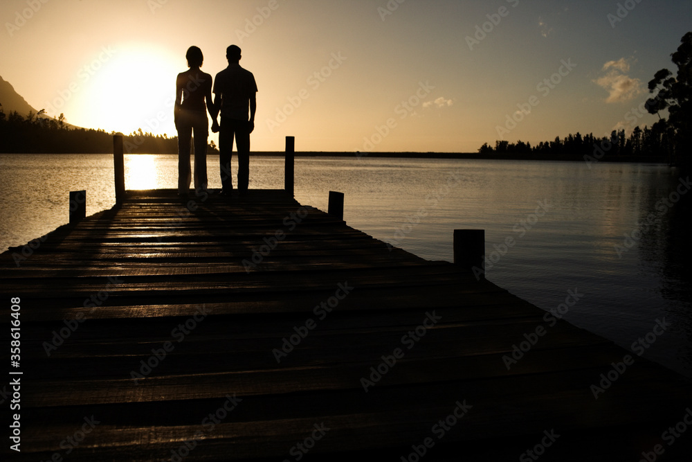 Couple Watching Sunset over Lake