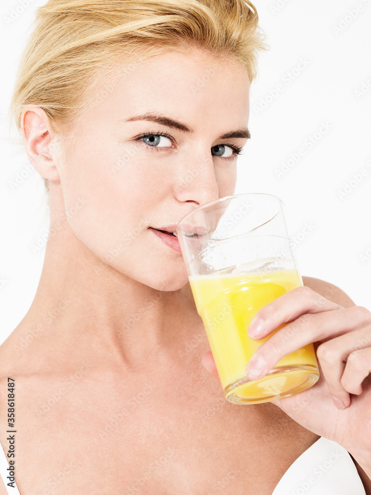 Young attractive blonde Woman Drinking Orange Juice Young attractive blonde Woman Drinking Orange Juice