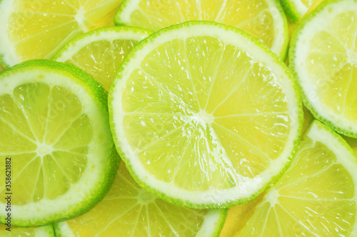 Lime sliced close-up. The concept of citrus fruits, vegetarianism, healthy fruits. Bright background image.