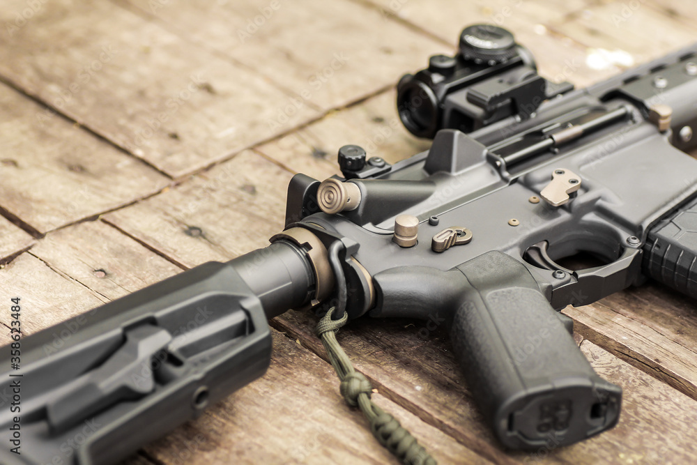 Obraz premium AR15 automatic assault rifle weapon with aim sight and flashlight