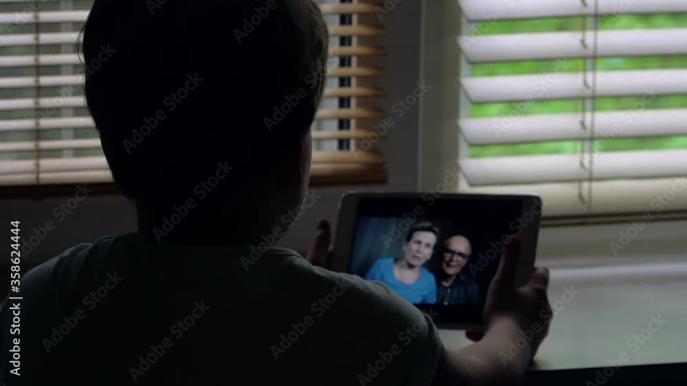 little child is chatting with grandparents by tablet, using video call by internet little child is chatting with grandparents by tablet, using video call by internet