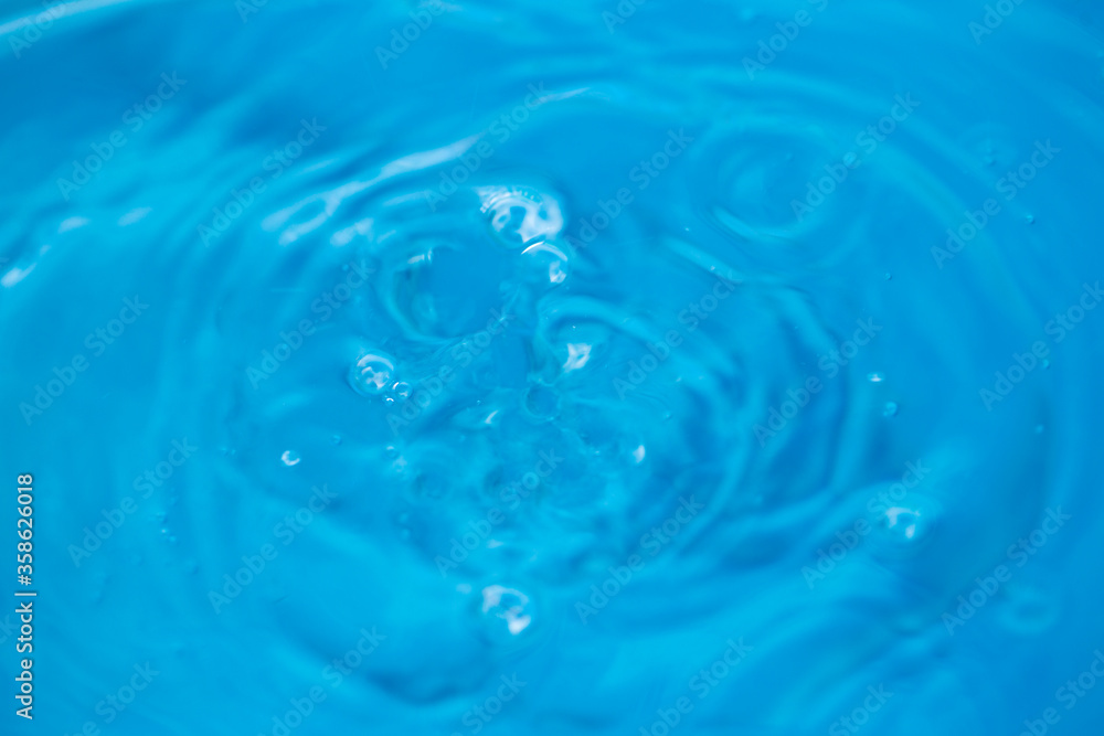 The round transparent drop of water, falls downwards. Selective focus. The round transparent drop of water, falls downwards. Selective focus.