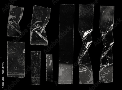 set of transparent adhesive tape or strips isolated on black background, crumpled plastic sticky snips, poster design overlays or elements. photo
