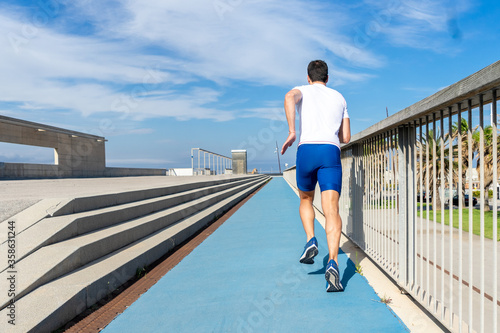 Fototapeta Naklejka Na Ścianę i Meble -  Young man running, motivation concept