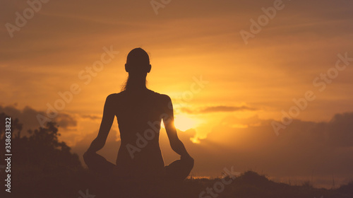 Peaceful meditation on a mountain at sunrise. 