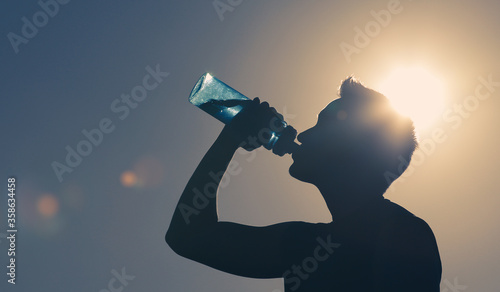 Young man drinking water.  photo