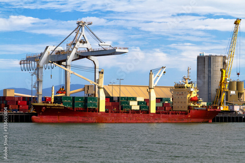 TOWNSVILLE, AUSTRALIA - NOVEMBER 28: Containers and cranes in the port on November 28, 2013 in Townsville, Australia. Townsville harbour is the third biggest in Queensland. photo