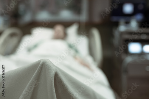 Sick person lying in hospital bed. 