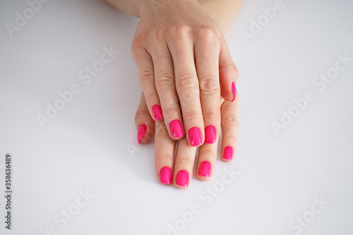 Beautiful female hands and beautiful manicure on a white background. Beauty and skin care concept.