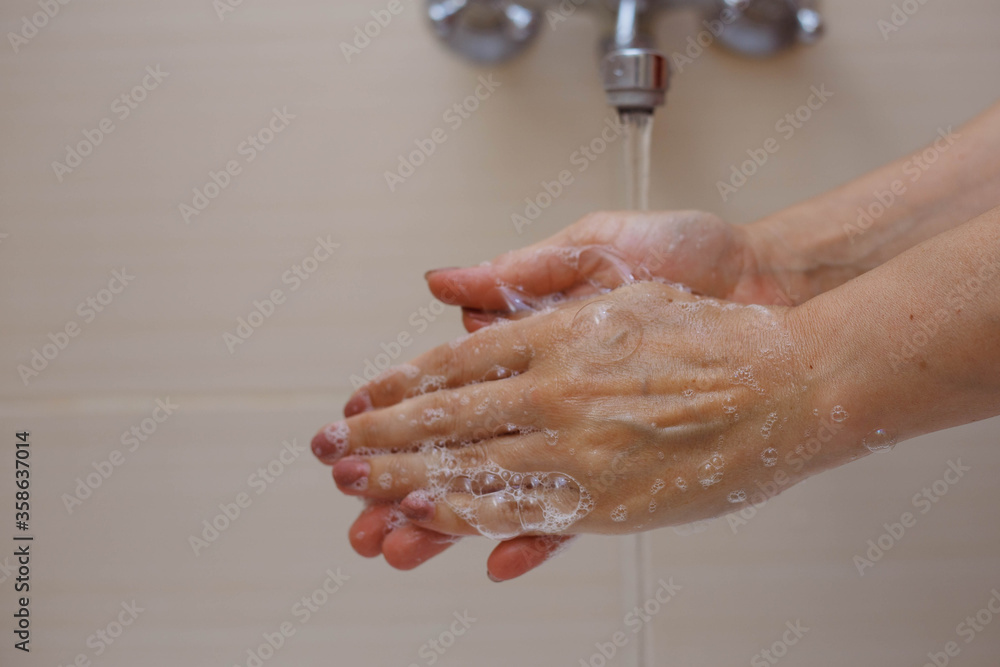 Fototapeta premium Person washing hands with antibacterial solution.