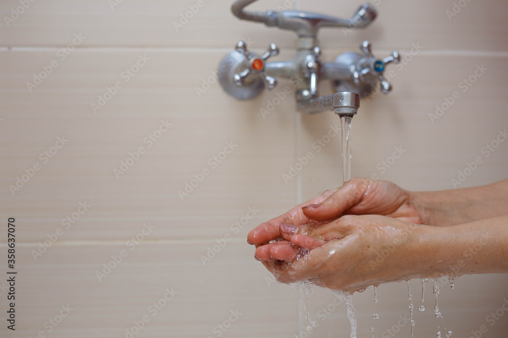 Fototapeta premium Person washing hands with antibacterial solution.