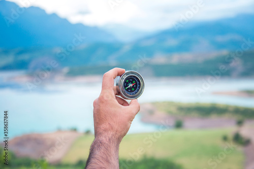 Compass in hand against a background of nature