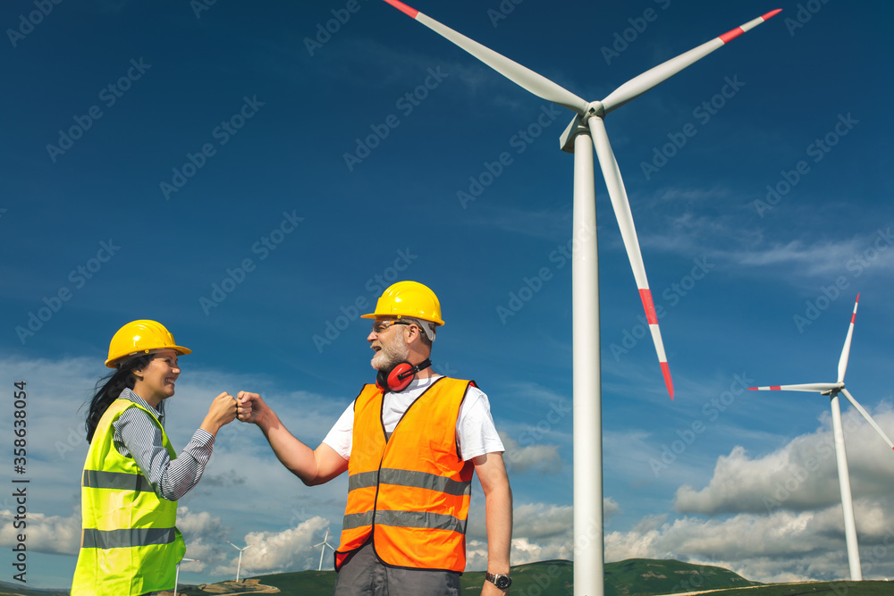 Windmill engineer shake hand new normal social distancing Windmill engineer shake hand new normal social distancing