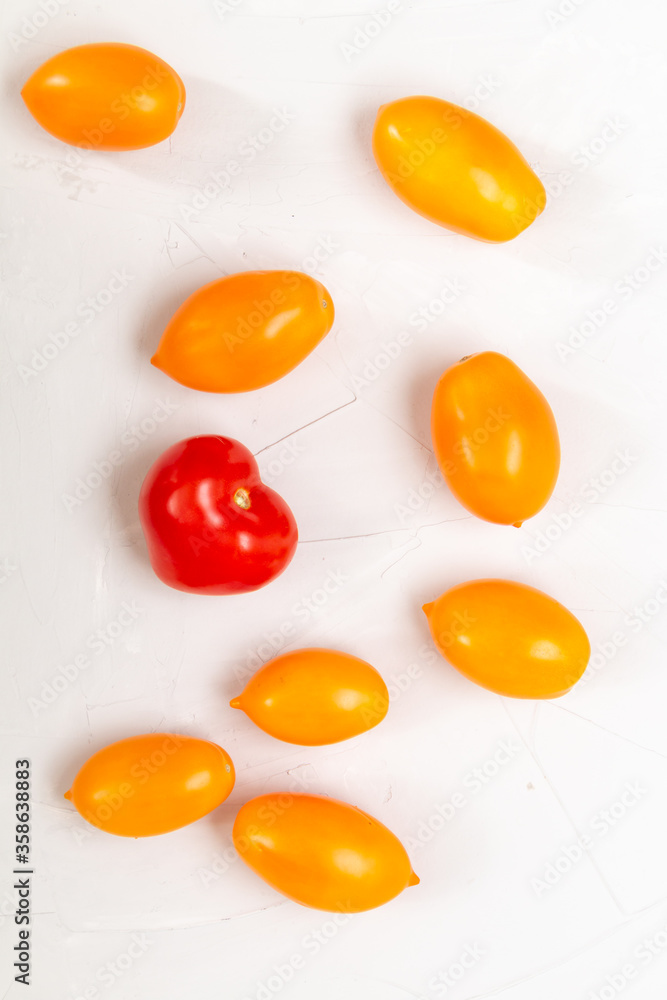 yellow fresh organic tomatoes pattern on a white background, empty space for text
yellow fresh organic tomatoes pattern on a white background, empty space for text