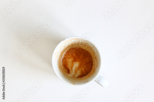 dirty empty coffee cup top view. top view empty and dirty cup of coffee on a white background