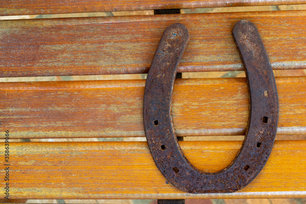 old and rusty horseshoe on wood old and rusty horseshoe on wood