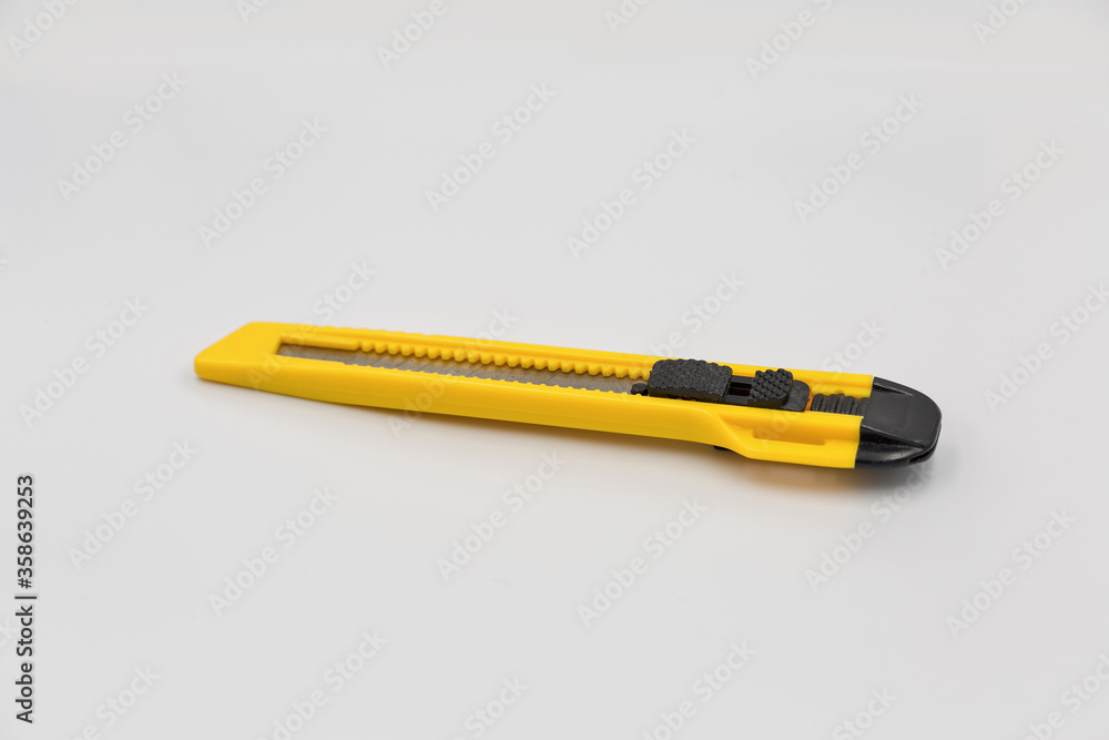 Office plastic knife for cut paper and other, closeup Office plastic knife for cut paper and other, closeup