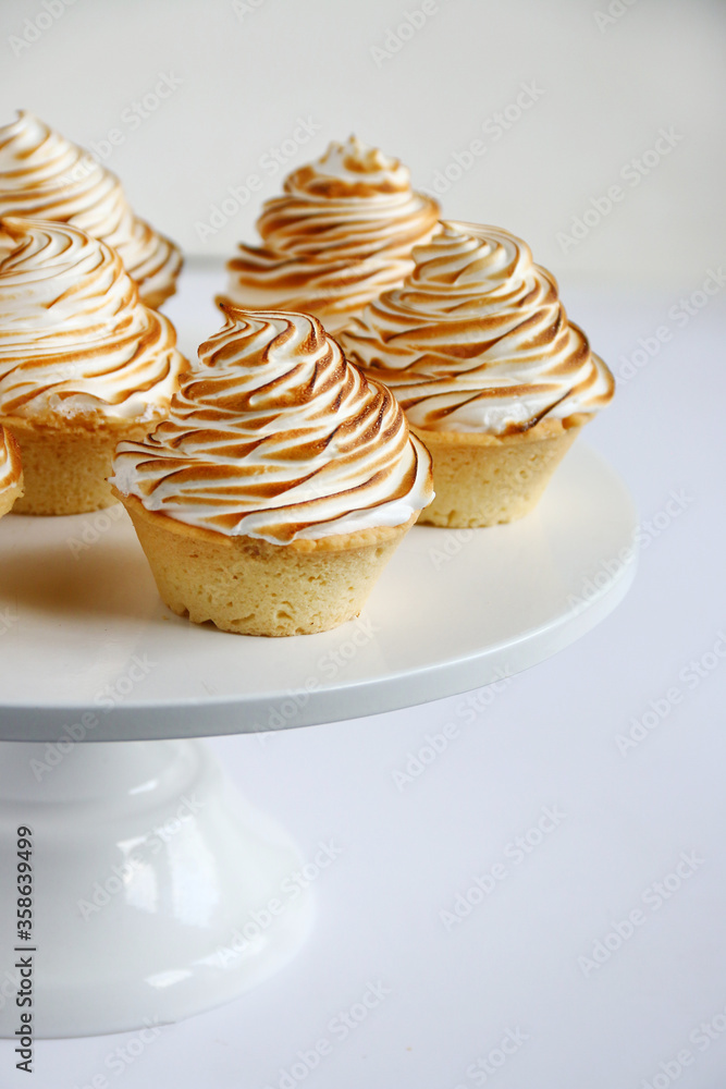 lemon meringue tart closeup on white background. lemon curd tart. tasty lemon mini meringue pie lemon meringue tart closeup on white background. lemon curd tart. tasty lemon mini meringue pie