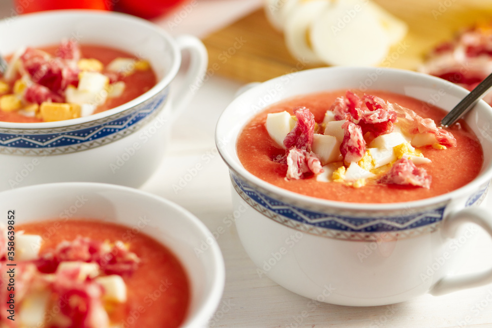 Tomato soup, salmorejo, with raw ingredients on a table Tomato soup, salmorejo, with raw ingredients on a table