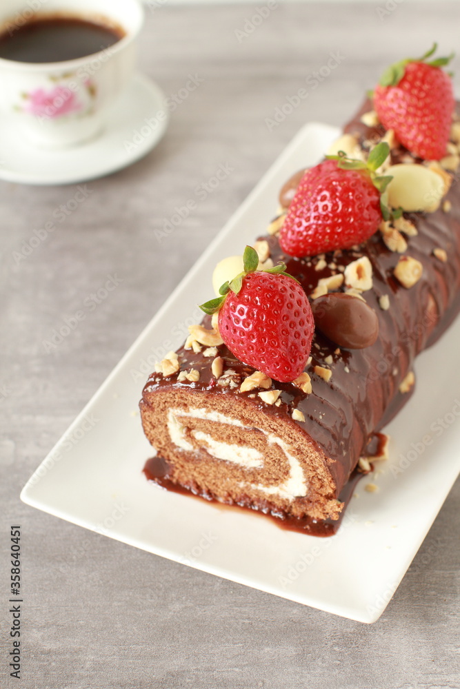 Chocolate cake roll with strawberries, nuts and cheese cream Chocolate cake roll with strawberries, nuts and cheese cream