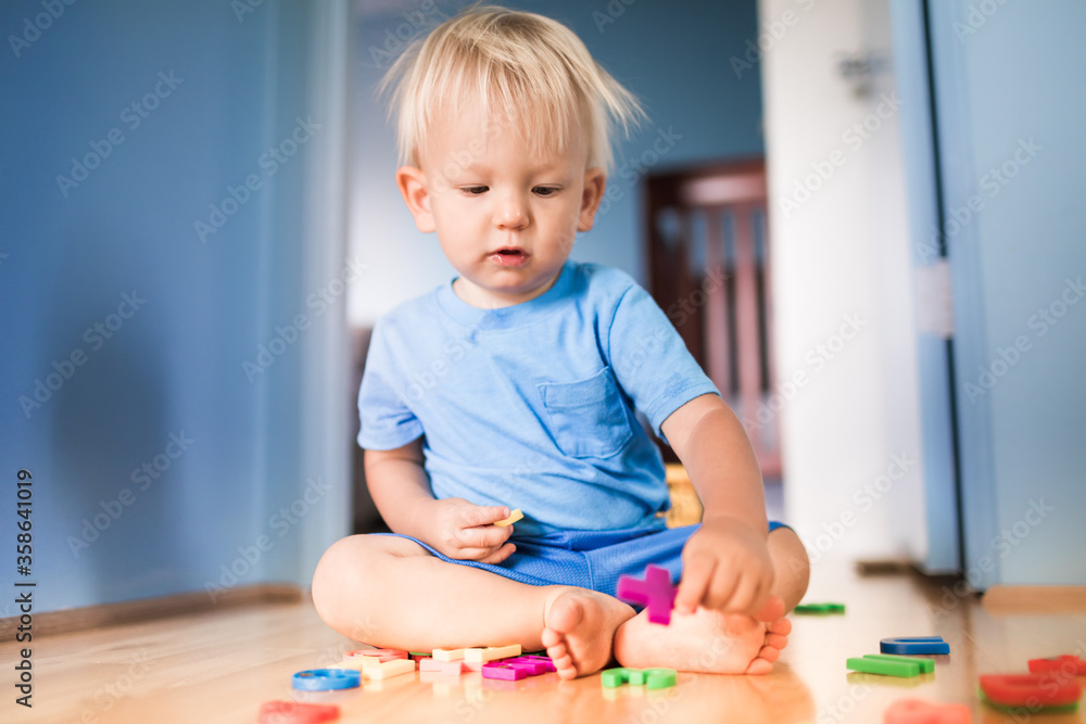 Toddler child playing at home with toys in bedroom Toddler child playing at home with toys in bedroom