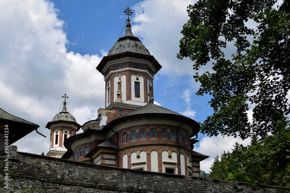Stone religious building of Christian Orthodox church built in the Byzantine style. Old Orthodox Monastery with a beautiful architecture. Romania, Sinaia.