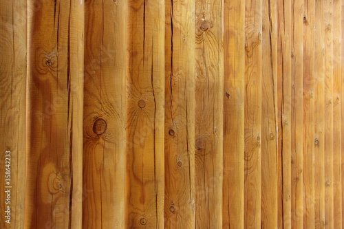 New wooden hewn logs fence construction, old russian style country vertical rustic texture for background