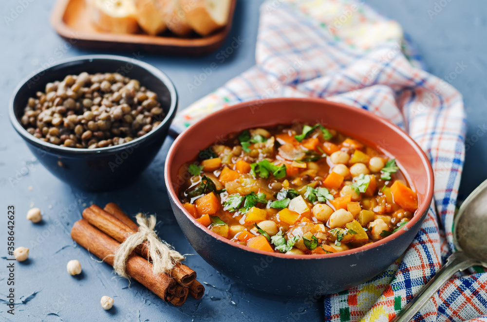 Moroccan spicy green lentils chickpea soup in a dark bowl Moroccan spicy green lentils chickpea soup in a dark bowl