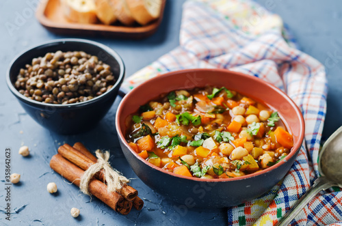 Moroccan spicy green lentils chickpea soup in a dark bowl