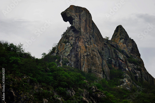 Stone mountain Quixadá Monoliths Natural Monument, formation of inselbergs at Ceará, Brazil, nature reserve. Chicken form, Broody Hen curious rock at Cedro Lake dam. Climbing travel destination.
