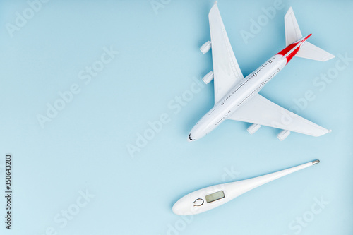 Airplane and thermometer on a blue background.