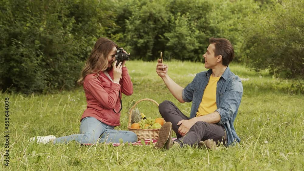Young, happy, loving couple having date in the park. Relations, friendship and love concept. Young, happy, loving couple having date in the park. Relations, friendship and love concept.