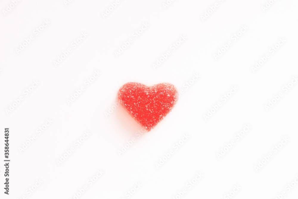 Red marmalade hearts in sugar on a white background. Marmalade sweets. Valentine's Day. Dessert. Copy space. View from above. Heart in hoarfrost and ice.