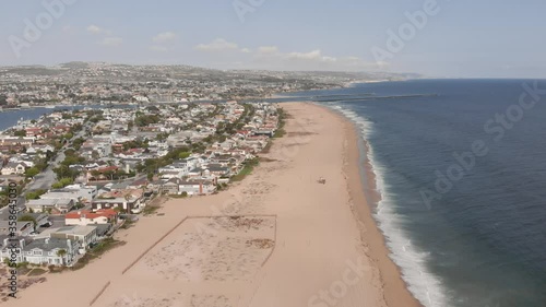 Wallpaper Mural Aerial shot ascending forward over empty sandy beach and residential area of Balboa peninsula towards Wedge and Newport Harbor entrance channel on calm sunny summer afternoon in Newport Beach Torontodigital.ca