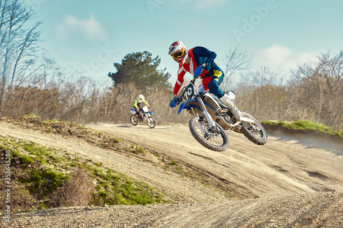 Motocross concept  a biker goes off-road making extreme skiing. In pursuit of adrinalin  sport concept. Dangerous sport.