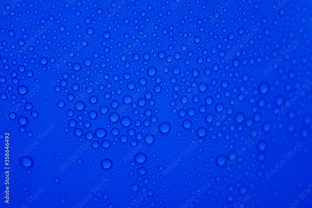 drops of pod on frosted glass on a blue background