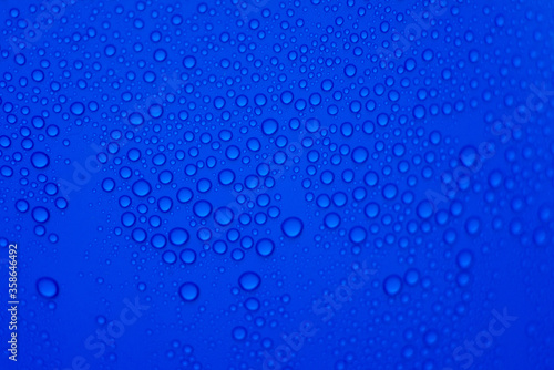 drops of pod on frosted glass on a blue background