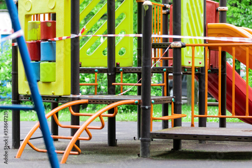Wallpaper Mural The play park of amusement and sports for young children is wrapped in red barrier tape. Outside. Prohibition of outdoor walks, prevention of the coronavirus influenza virus covid-19. europe. Torontodigital.ca